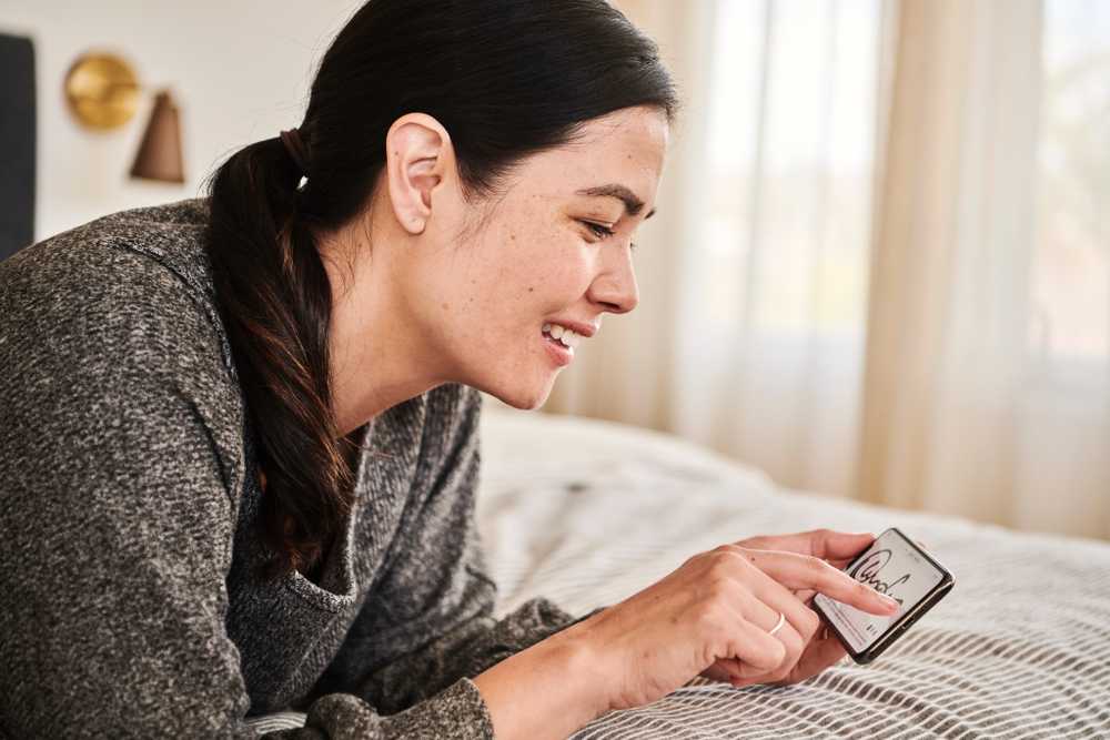 Woman writing signature on phone